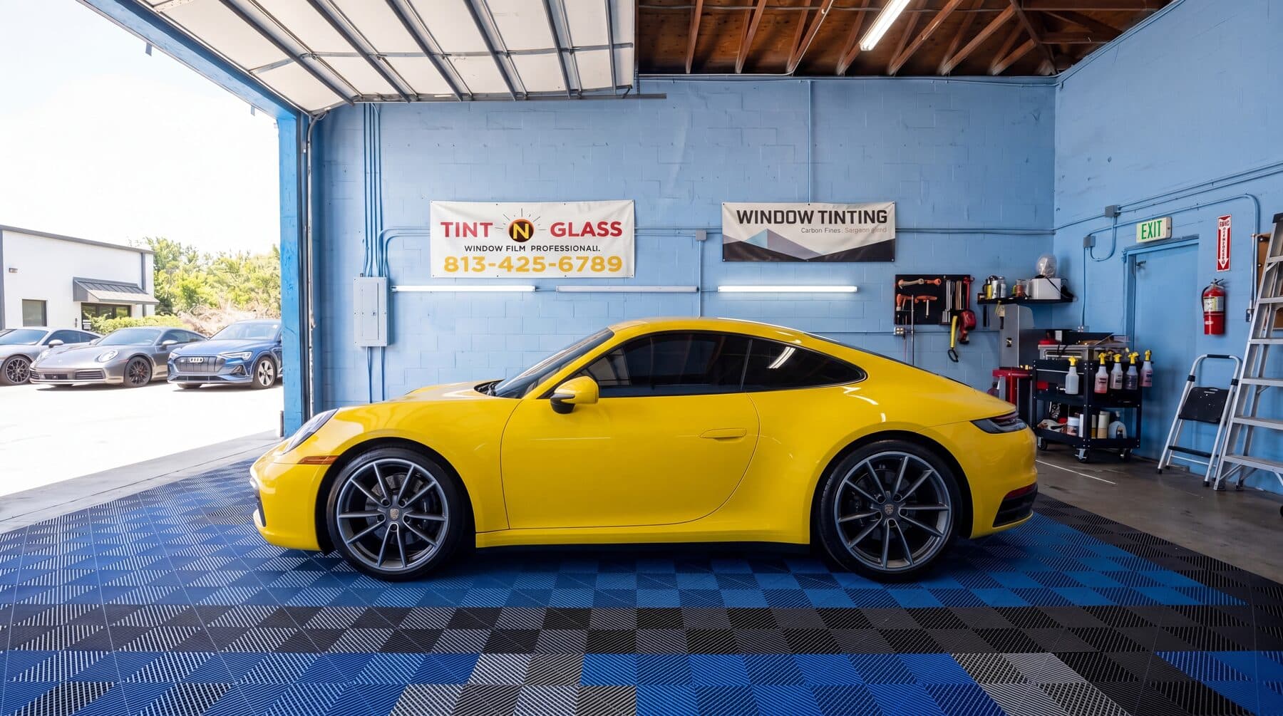 Yellow vehicle in the Tint N Glass bay representing Hudson service area work