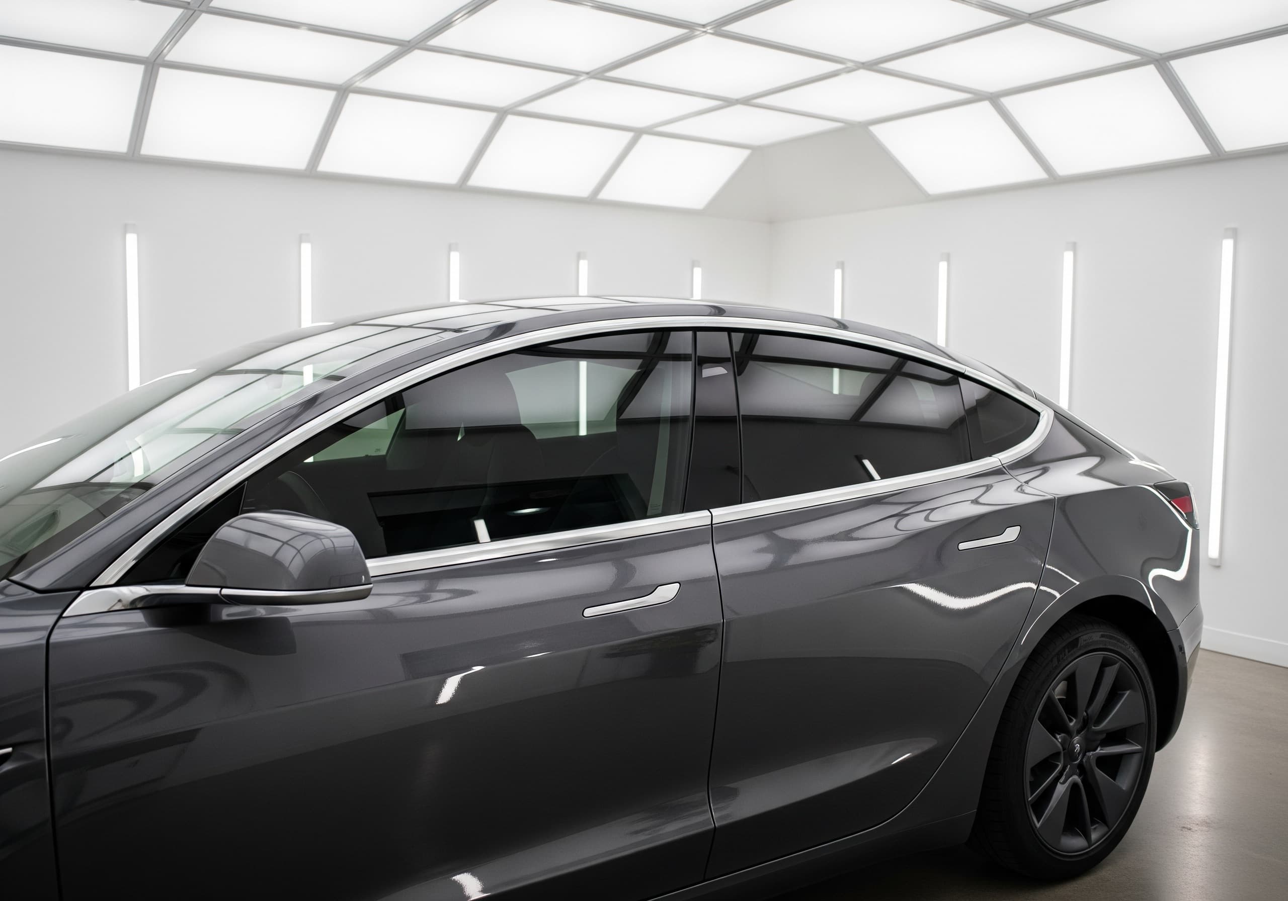 Tesla side and rear glass shown inside the Tint N Glass service bay