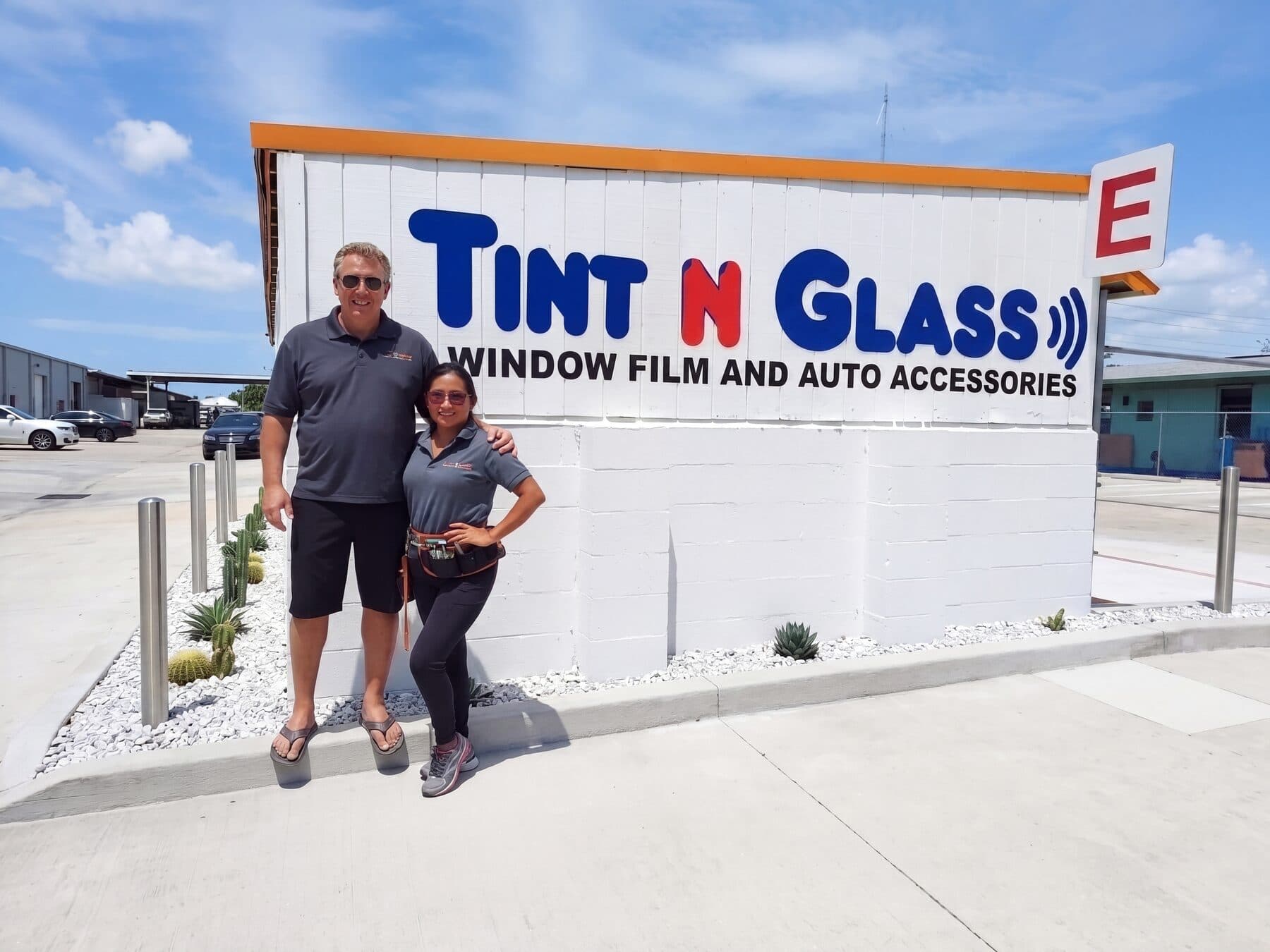 David and Perla Taylor standing together next to the Tint N Glass sign